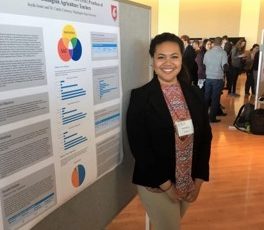 Jayda Jessie standing next to research poster.