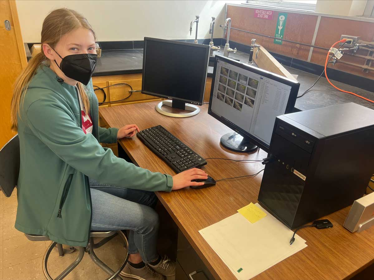 Nora Abelsen working at desk in office.