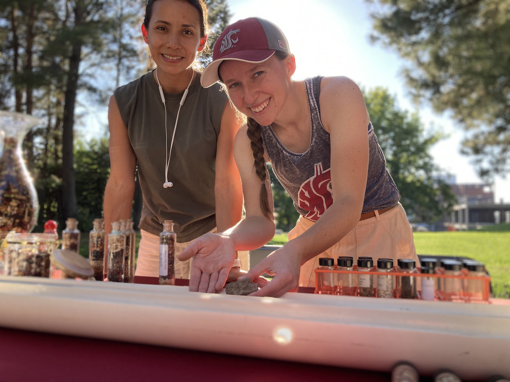 A student in a cougar cap and tank top points out a specimen at a booth at the annual CAHNRS Fall Festival