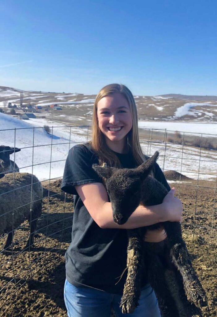 Student holding goat