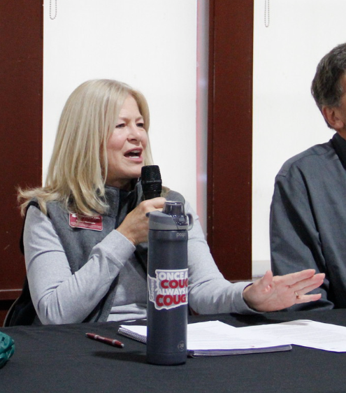 Nancy Deringer, Associate Dean of Student Success and Academic Programs, speaks into a microphone.