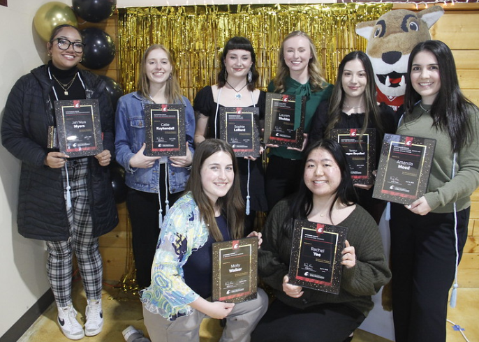 Students hold up their awards certificates at the CAHNRS student awards ceremony.