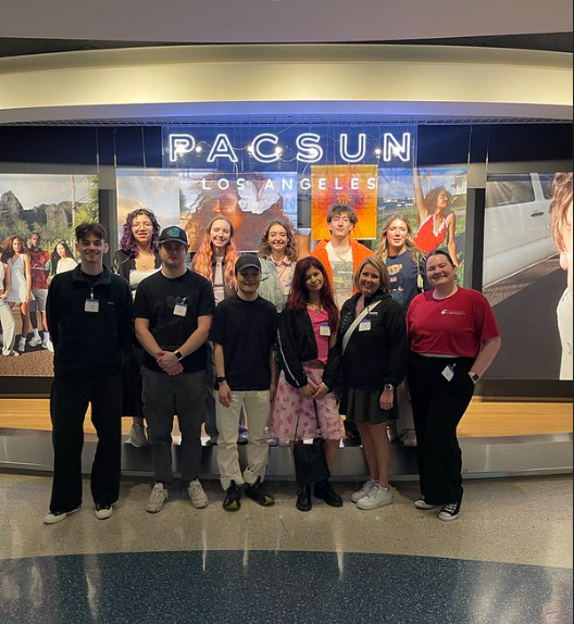 Students stand in front of the Pacsun Los Angeles Sign.