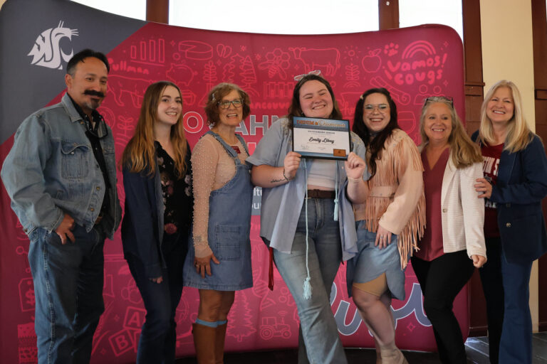 Emily Libey receives her award at the CAHNRS Student Awards 2025, surrounded by her friends in CAHNRS SSAP.