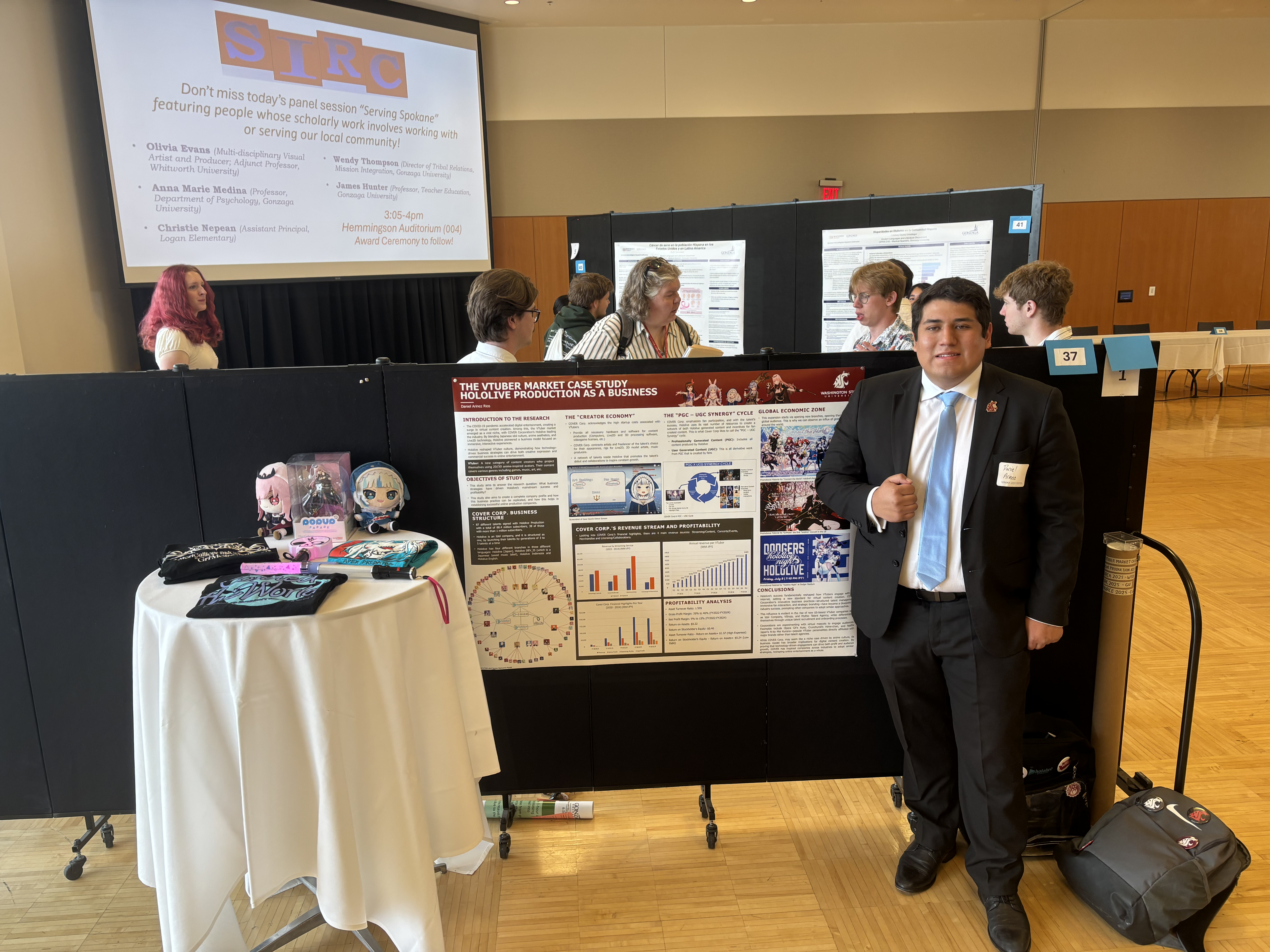 Daniel Arinez poses in front of his poster for the VTuber Study research paper.