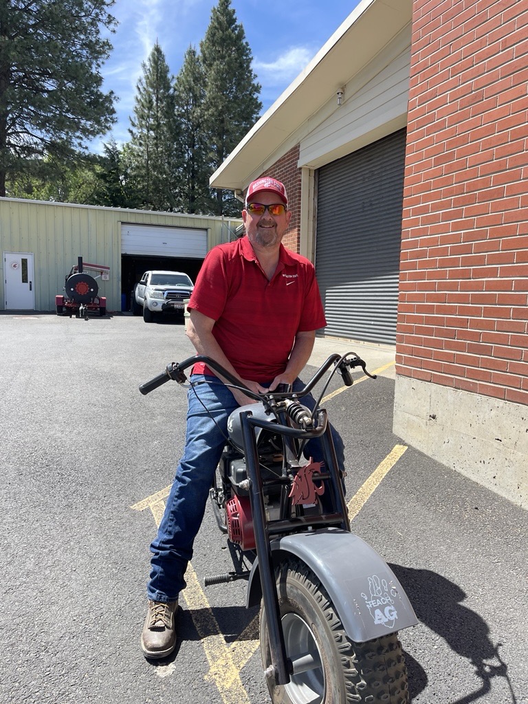 J.D. Baser poses on his WSU logo motor bike.