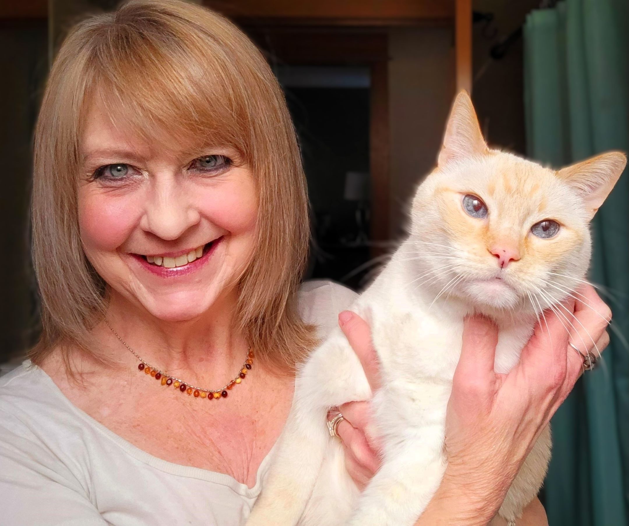 Lee Tatum holds up a cat.