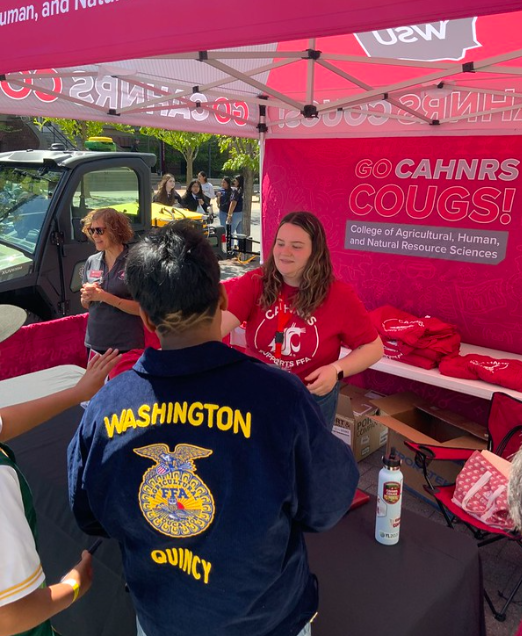 Emily Libey handing out t-shirts to FFA students.