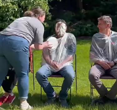 Miguel Inzunza getting brutally pied in the face with whipped cream by Emily Libey.