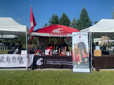 A Cougars tent with the CAHNRS tablecloth and our banner at the Crave event.