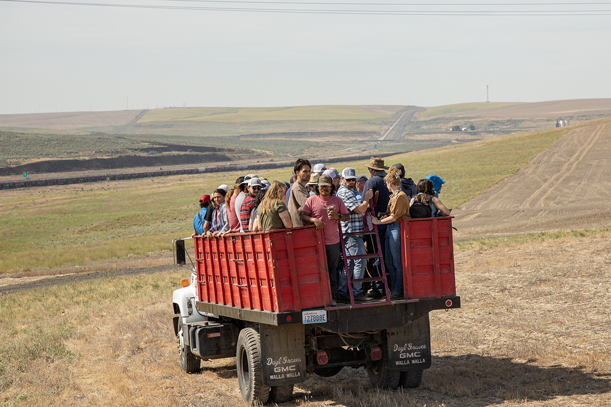 Field day tour attendees stand in the back of a truck as they are transported to a day of education and fun.