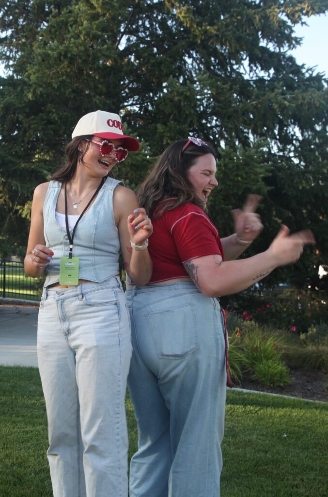 Emily Libey and Brooke Stutzer dress in demin Coug outfits and dance and laugh at the Crave Festival.