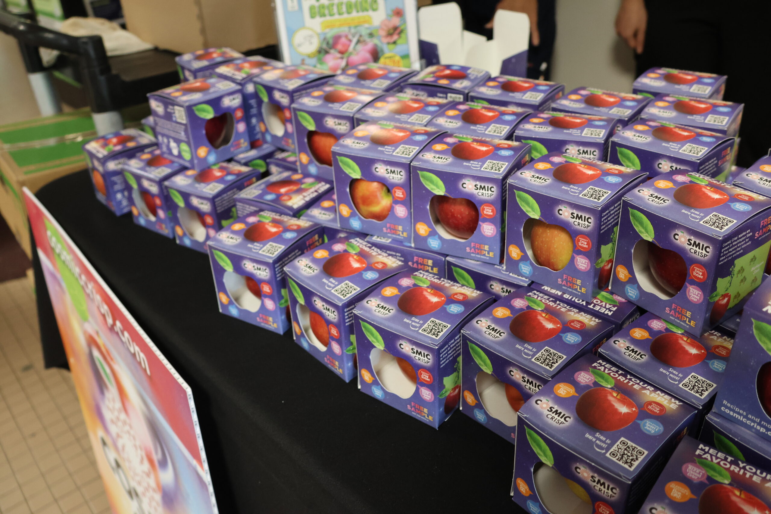 Cosmic Crisp apples in galaxy-print boxes.