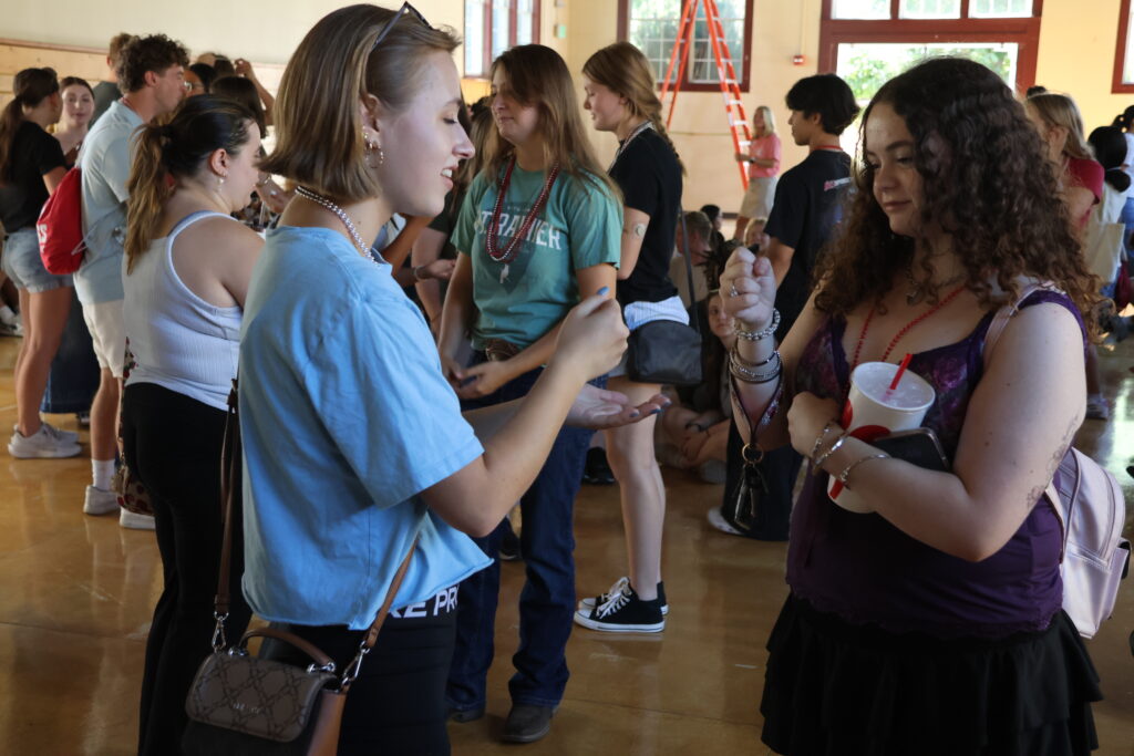 Students play rock-paper-scissors.