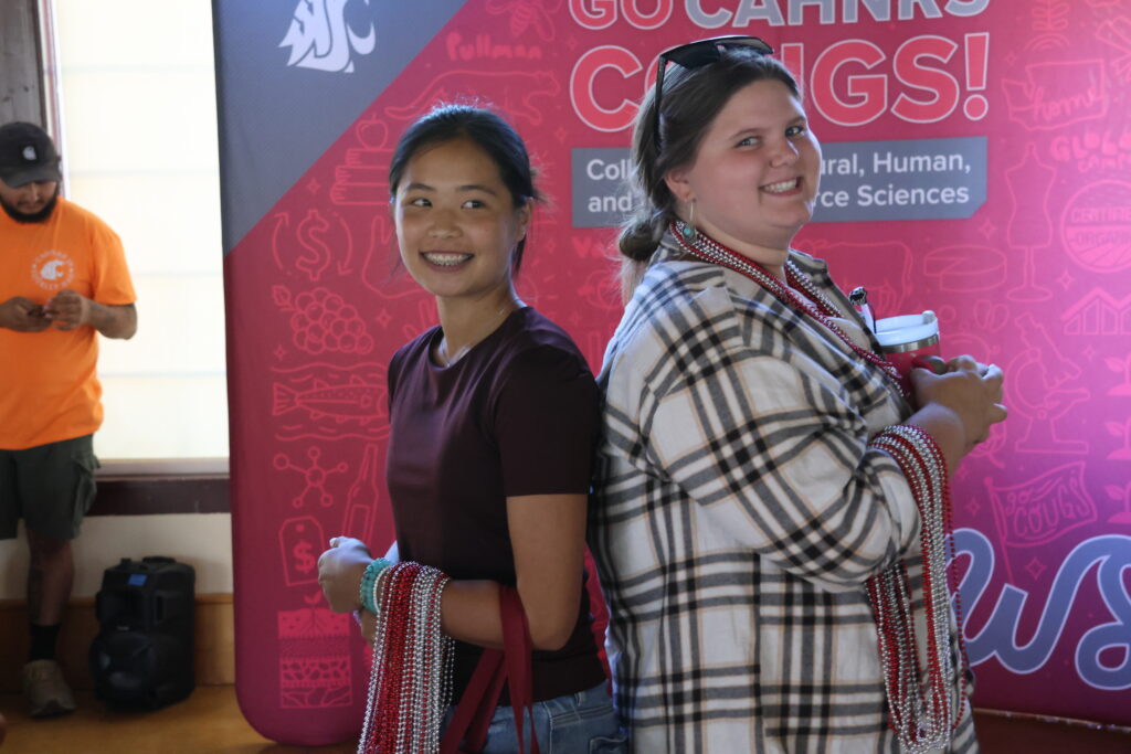 Bead winners pose proudly with their many strings of beads.