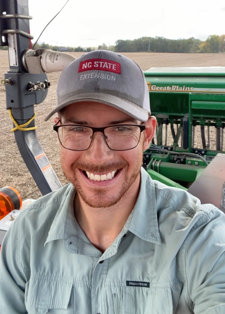 Morgan Menaker's profile picture in the field with equipment in the background