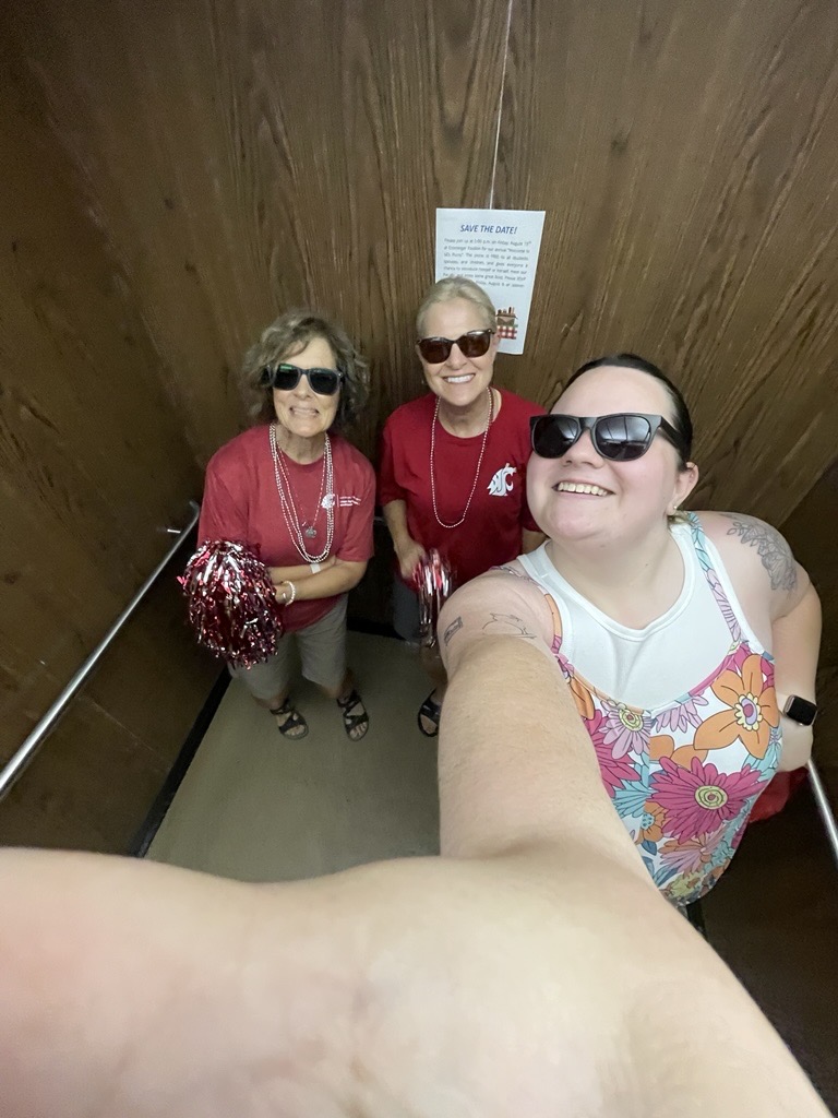 Emily Libey takes a top-view selfie pose in the elevator of Hulbert Hall with Judy Hopkins and Nancy Deringer.