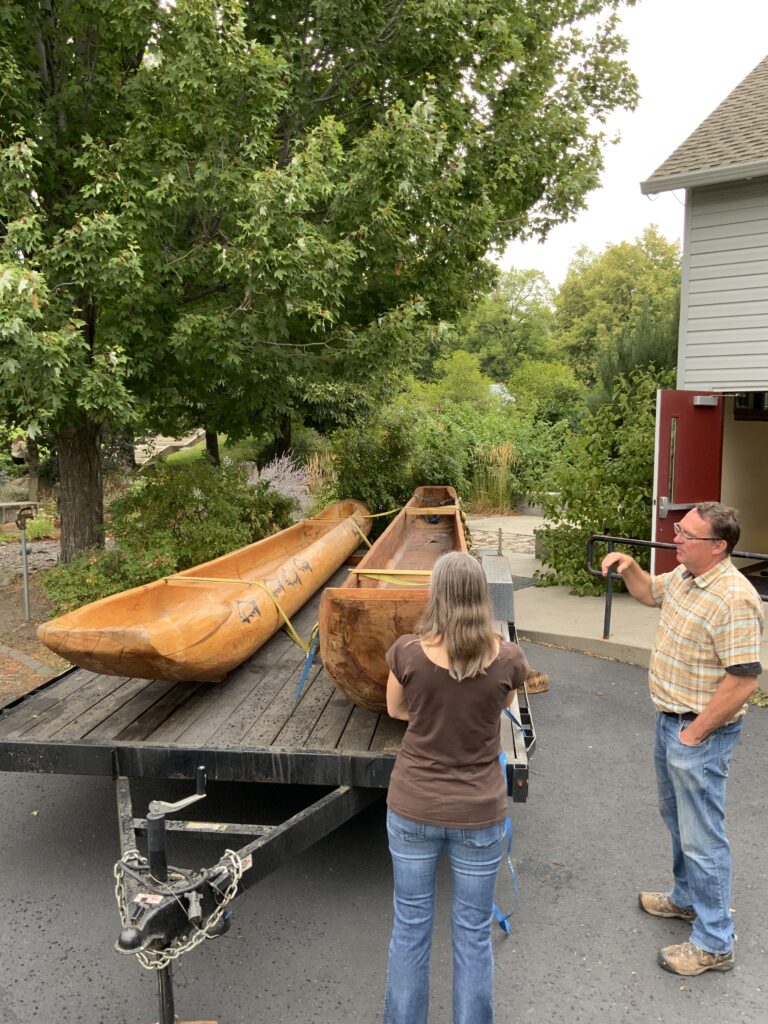 Two large canoes are displayed at the 2025 Science and Research Fair