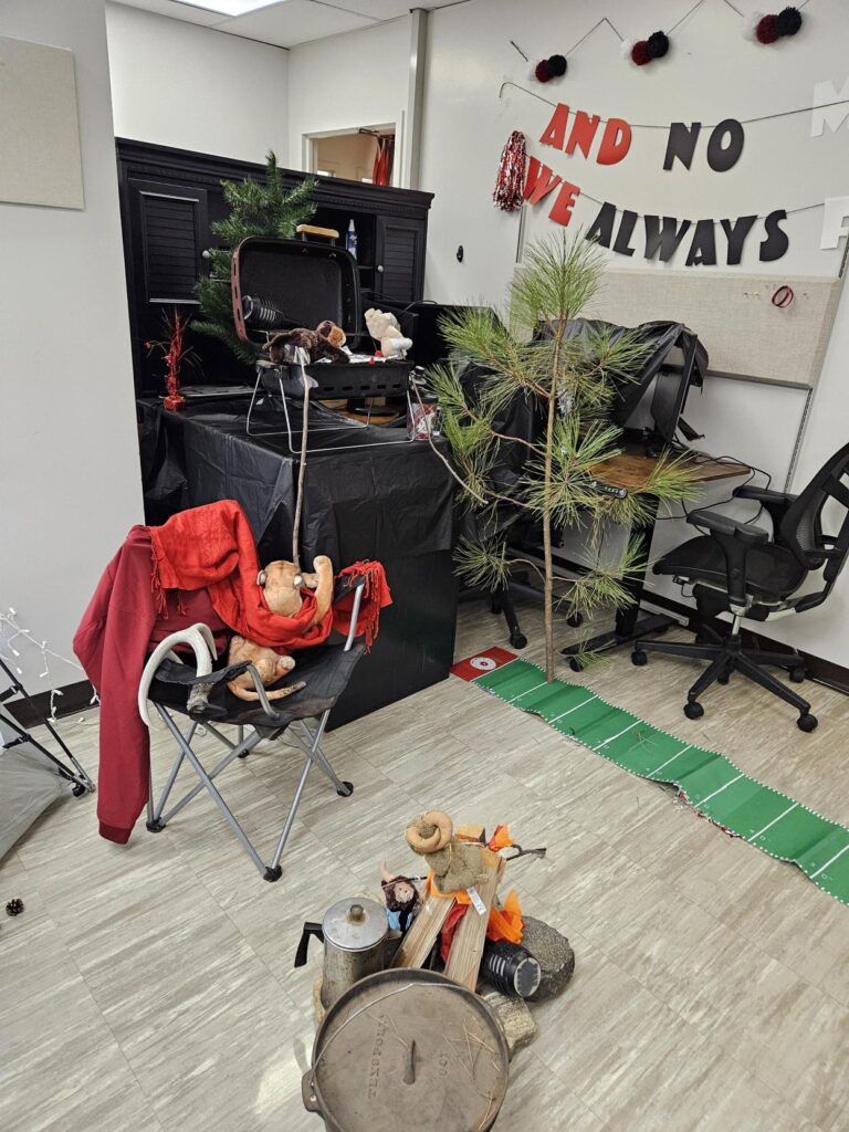 An elaborate camping scene with a barbeque is set up, with little cougar figures participating