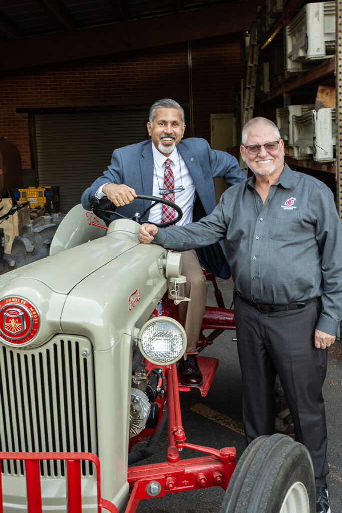 Gordon Davis and Dean Raj Khosla pose on a vintage tractor truck
