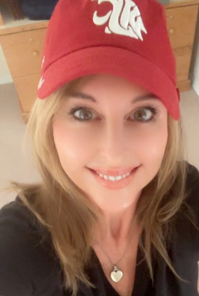 Dawn Medina adorns a WSU hat and smiles for the camera in a fun selfie.