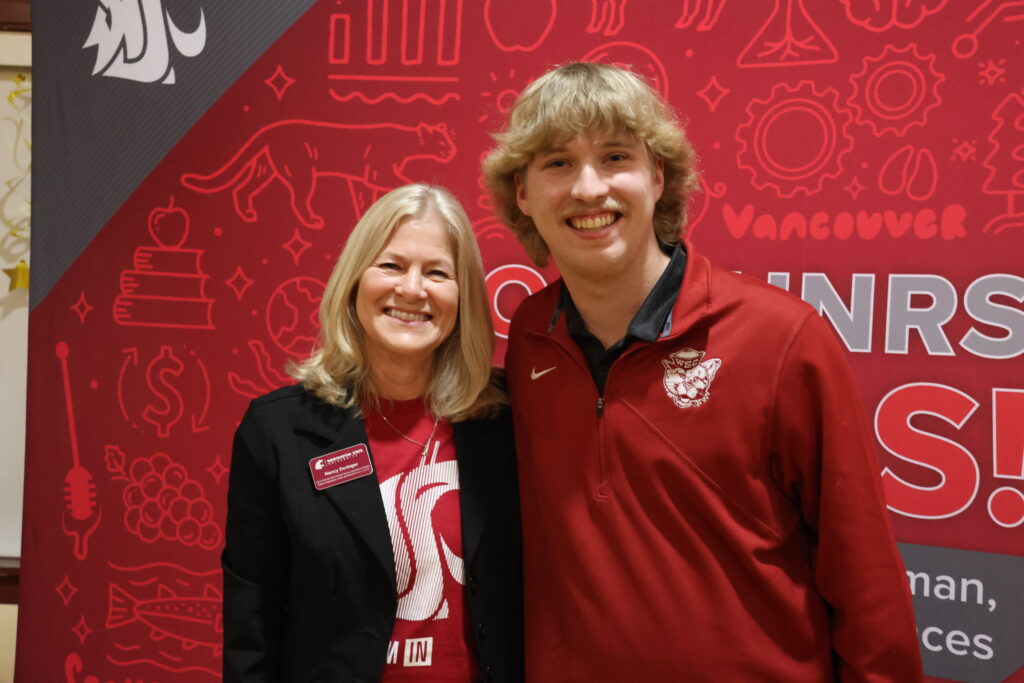 Nancy Deringer poses with a student