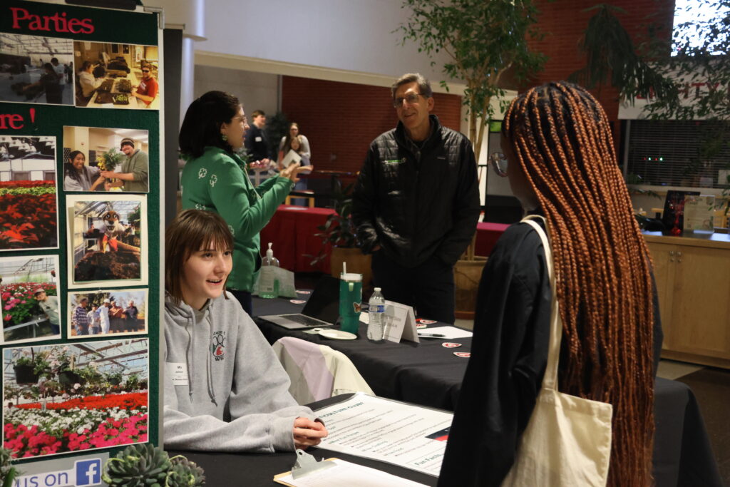 A student approaches a booth at the CAHNRS Career Fair and Networking Night.