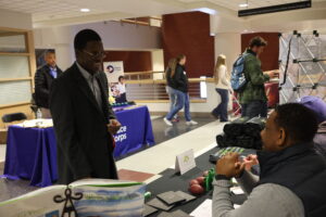 A student in professional dress speaks to an employer at the CAHNRS Career Fair and Networking Night.