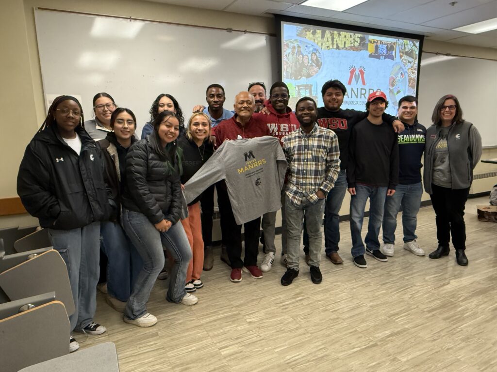 MANRRS students pose with Regent Cerna and a MANRRS sweater.