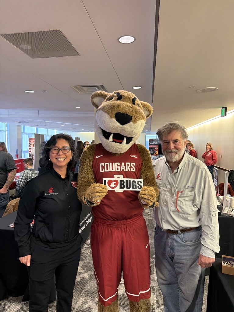 Butch poses with Entomology chair, Laura Lavine, with an I Love Bugs sign.