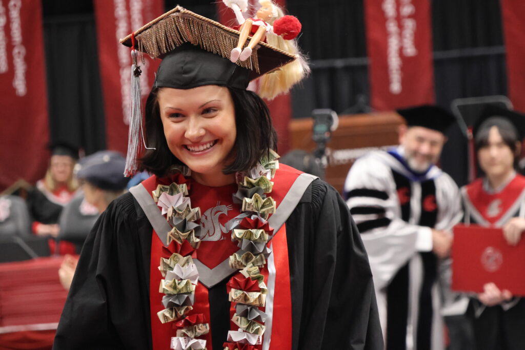 WSU graduate smiling at graduation.