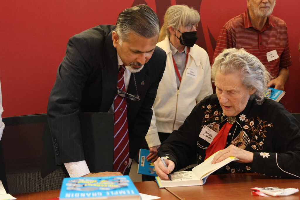 Temple Grandin signing her book next to Dean Khosla.