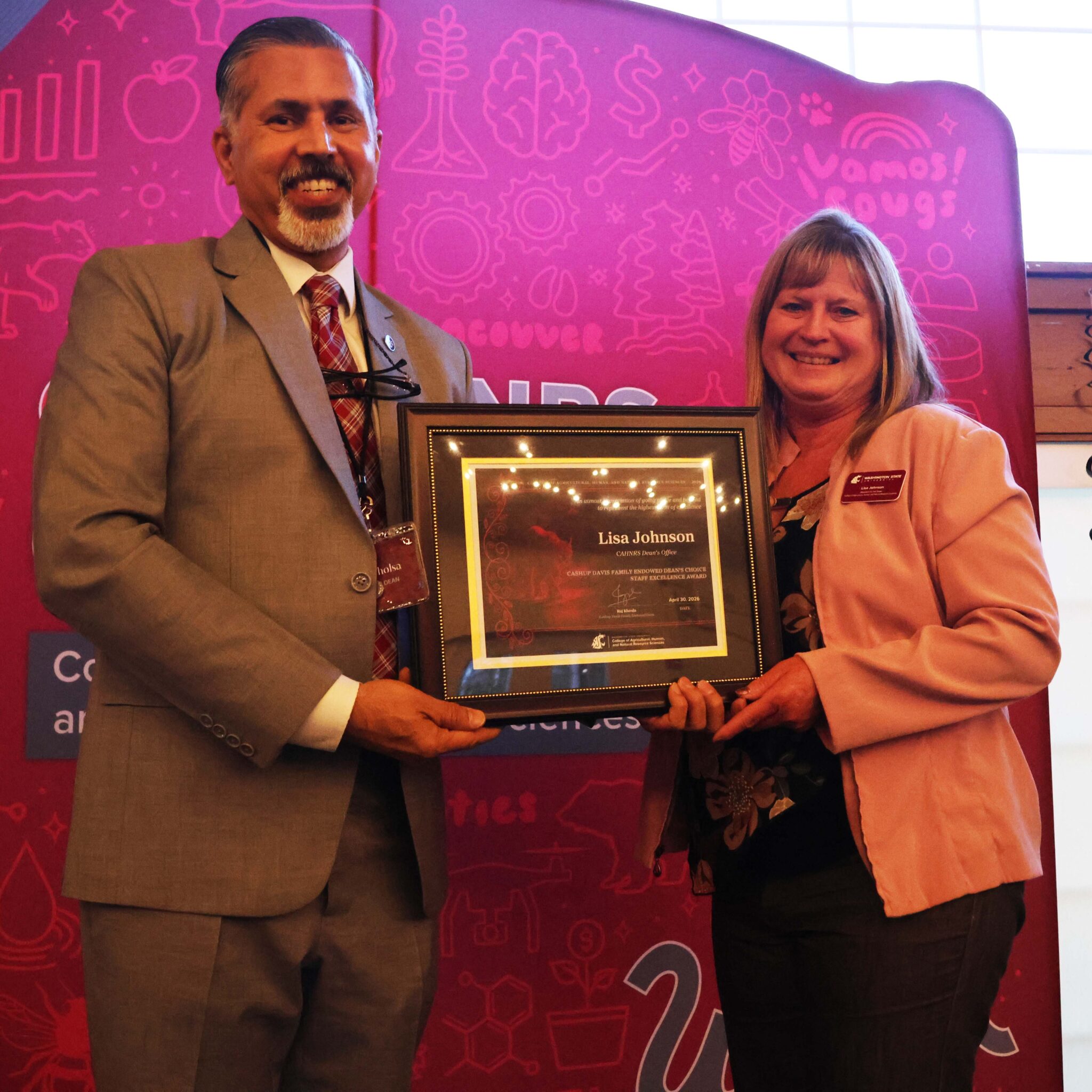 Lisa Johnson receiving her award from Dean Khosla.