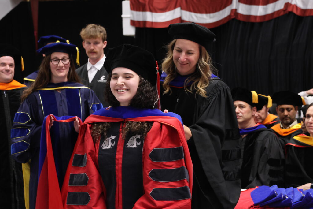 WSU Graduate student being hooded by their professor at graduation