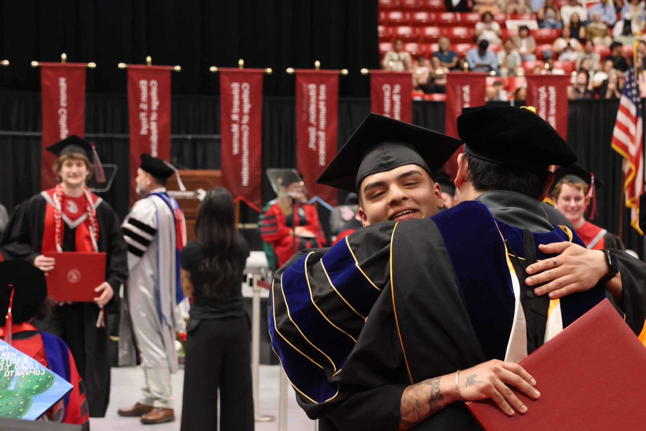 Graduate hugging a professor at Graduation