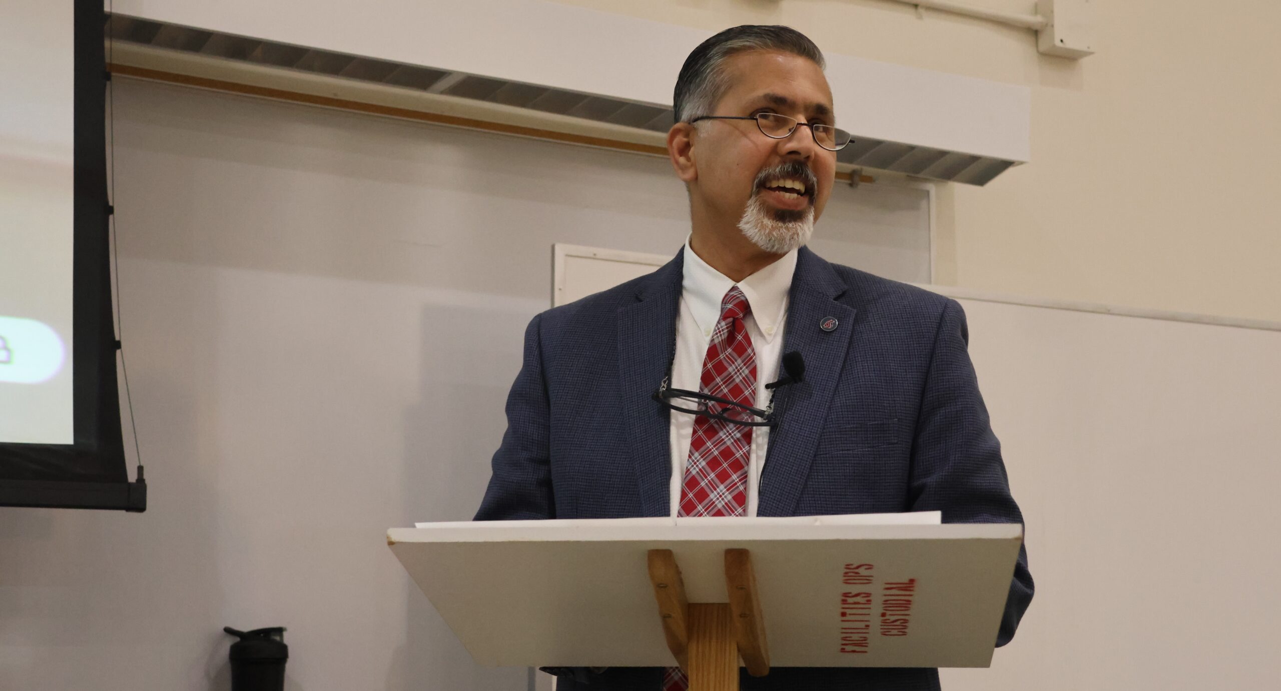 Dean Khosla stands and gives an address to the college.