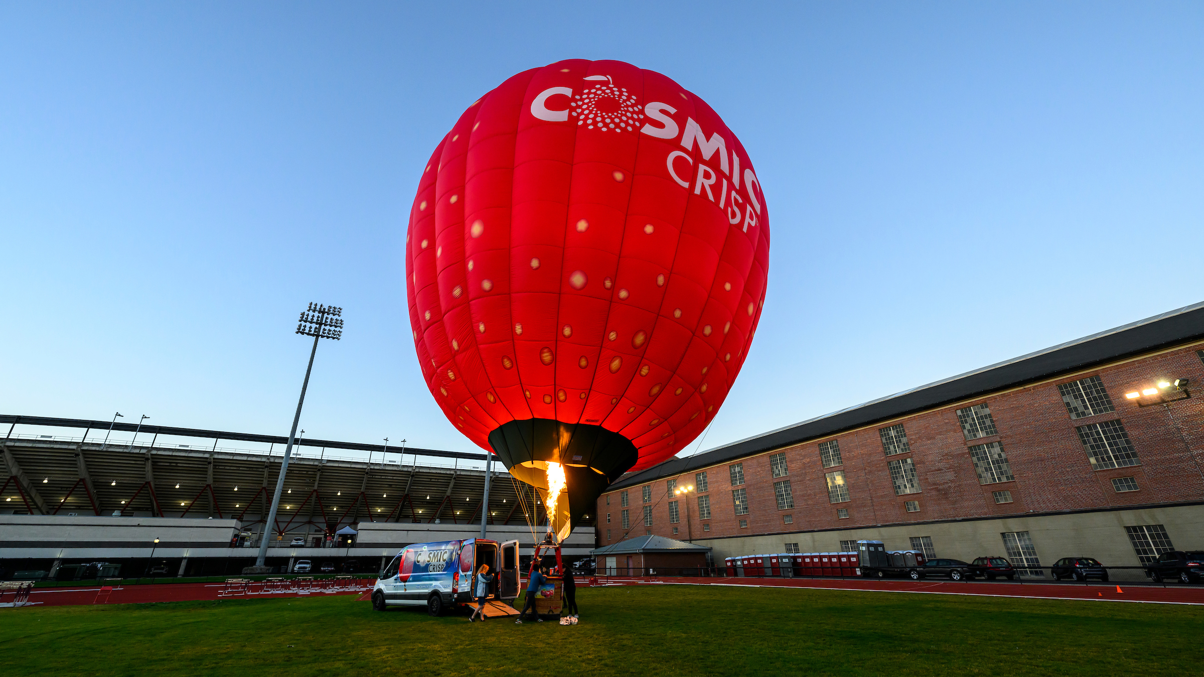 The Cosmic Crisp(R) hot air balloon inflates using flame on WSU's Mooberry Track