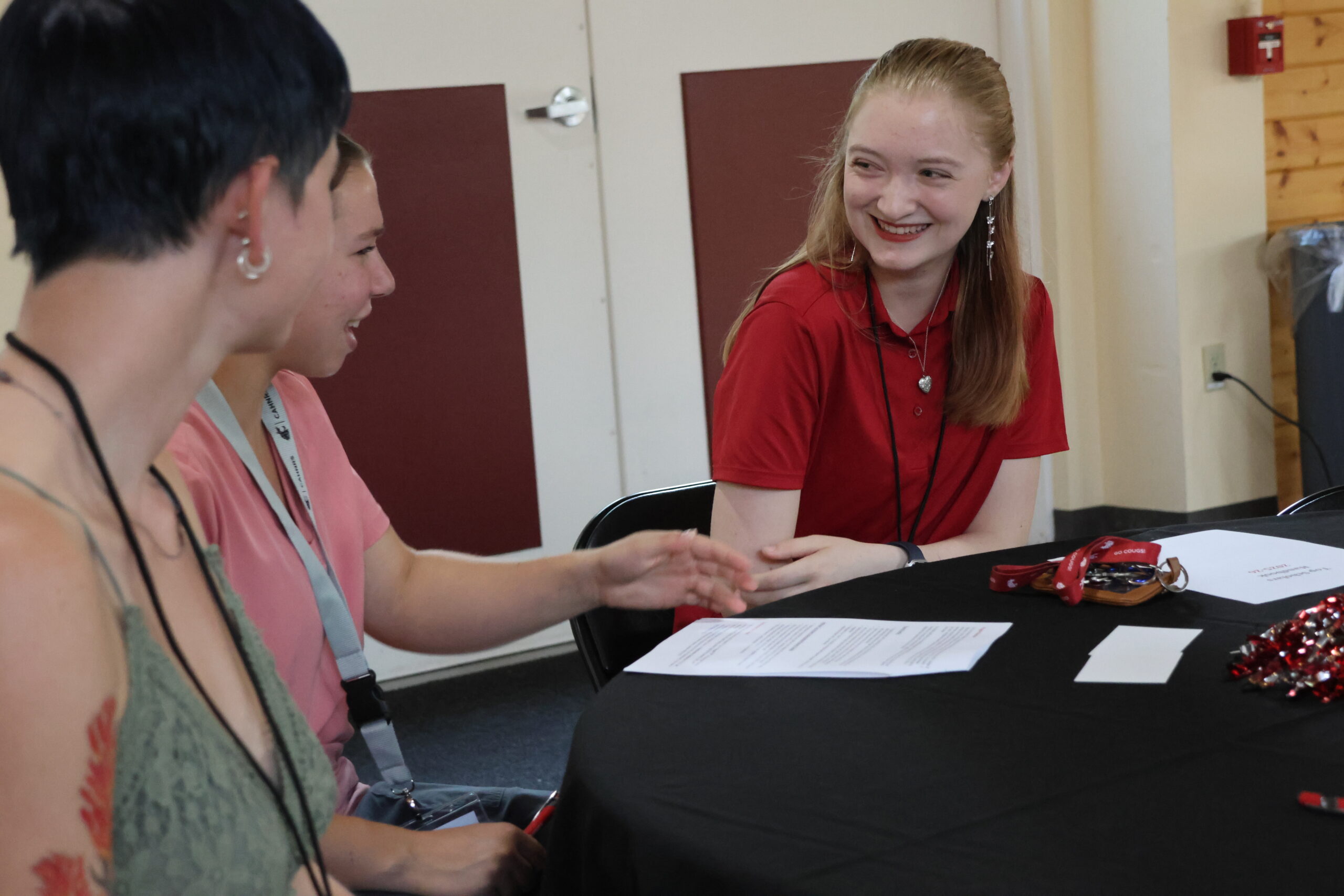 Students smile brightly, sitting at a table at the Celebration dinner.