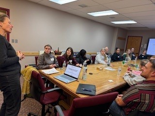 Students listen intently to a lecture in a conference room