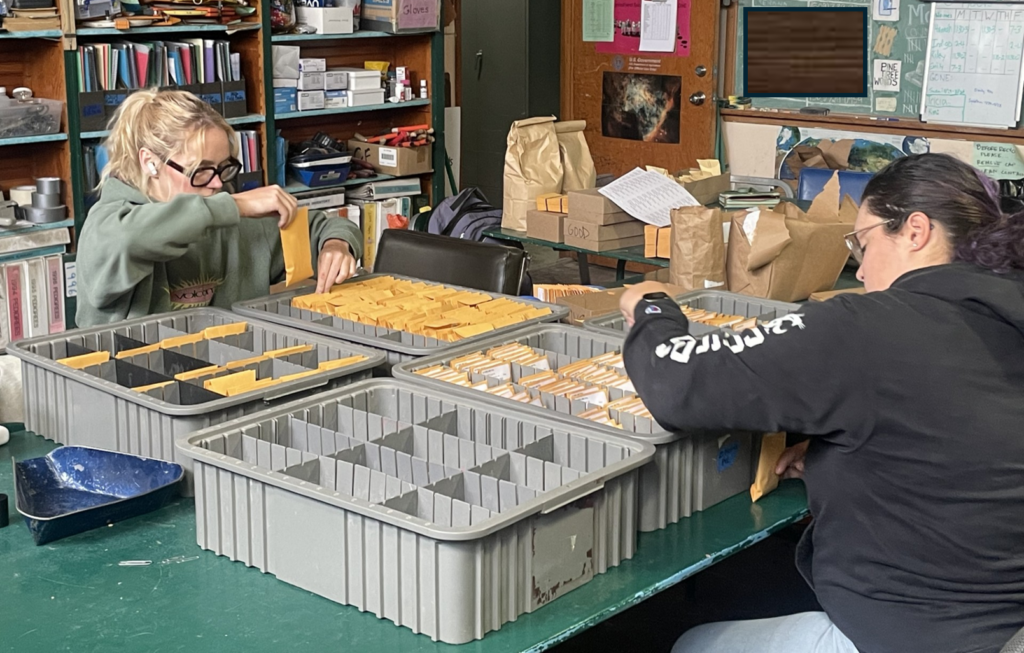 Putting Variety Testing Program seed packets in order.