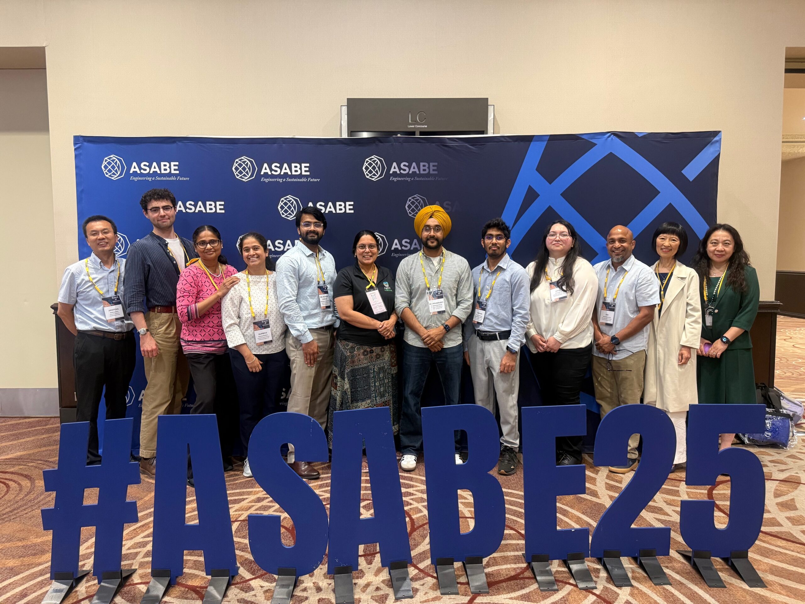 A group of twelve people standing together at the ASABE 2025 meeting.