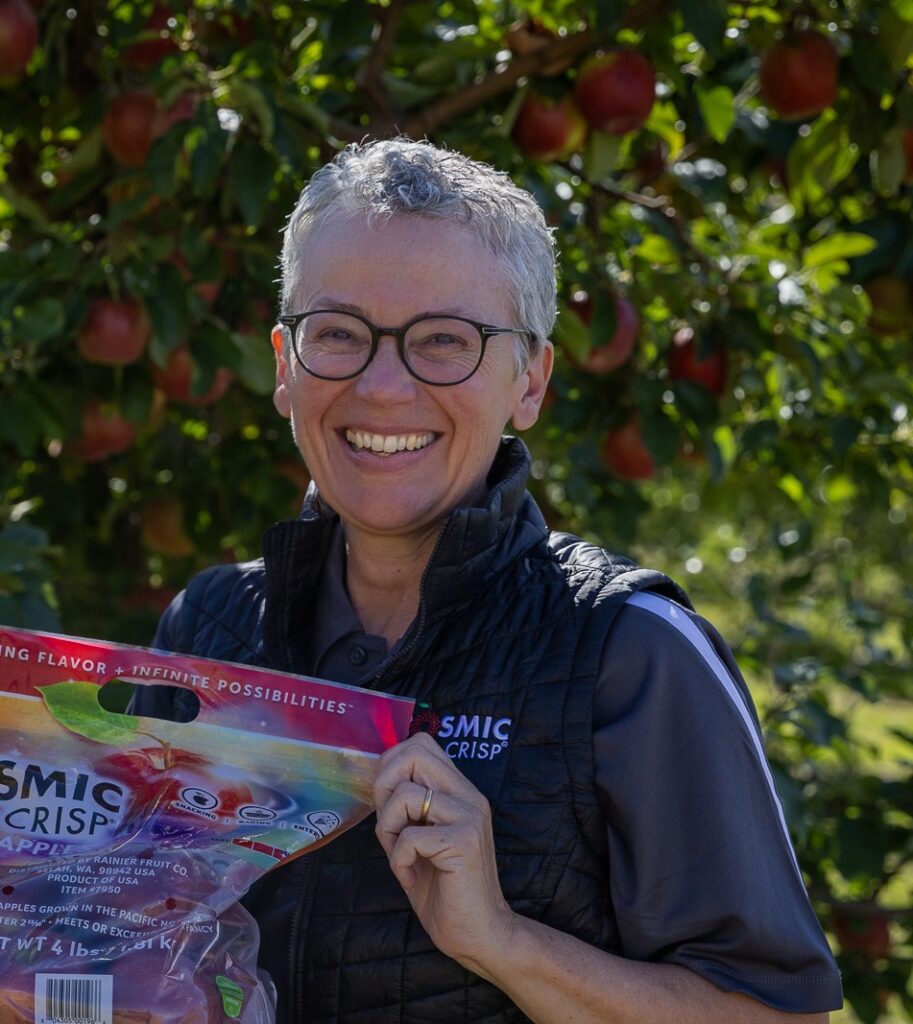 Kate Evans holding a bag of WA 38 apples