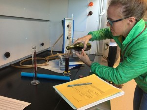 Student pouring wine in lab