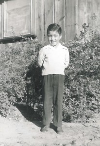Pre-kindergartener Lynell Tanigoshi stands by his farmstead home, circa 1945. (Photo courtesy of Lynell Tanigoshi)
