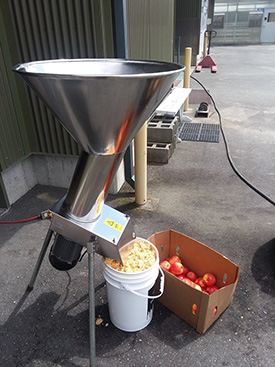 A portable cider press in action