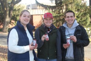 Cougar Quality Meats students hold shakers of Cougar Seasonings
