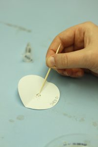 Cress seeds manipulated by a toothpick.