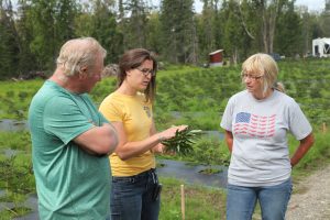 Garfinkel talks with growers about the health of their peonies during a 2016 Alaska field visit.