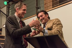 Stepehn Jones accepts the Pellegrini award at a podium from Tom Owens.