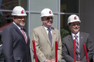 Wright, Schulz and Schoesler, in hard hats, with shovels, at groundbreaking.